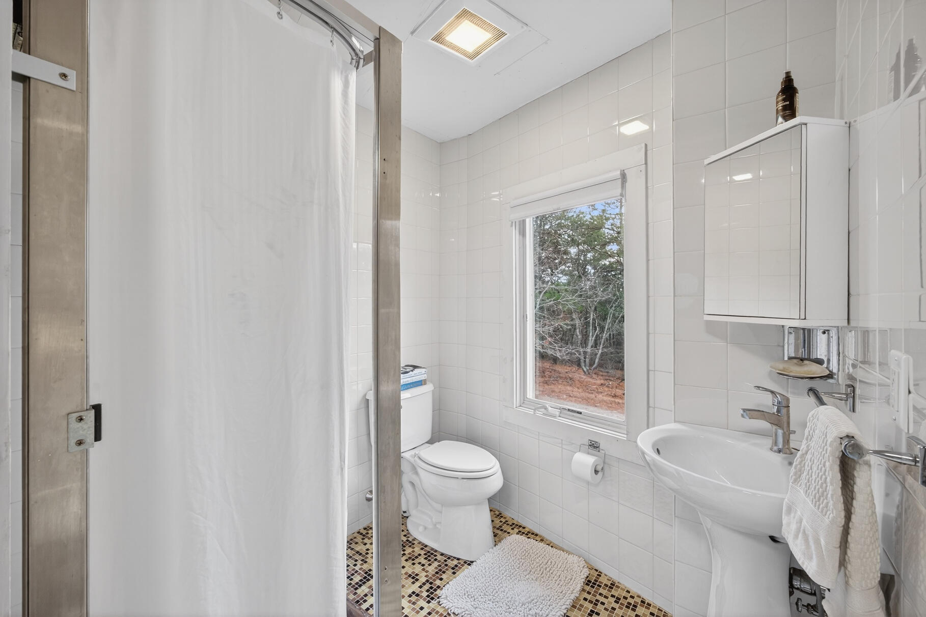 19 Old Bridge Road Truro, MA 02666 - Photo 19 of 27 a bathroom with a toilet a sink and a bathtub