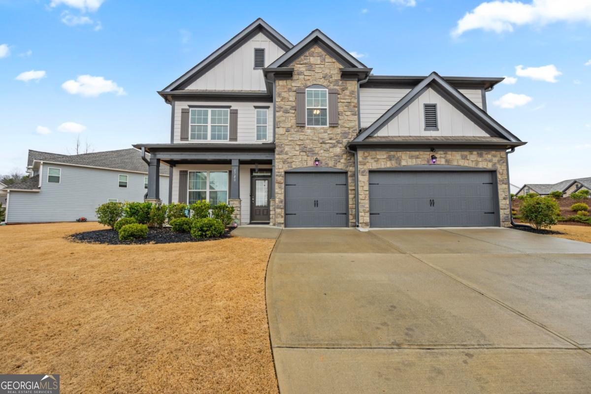 a front view of a house with a yard and garage