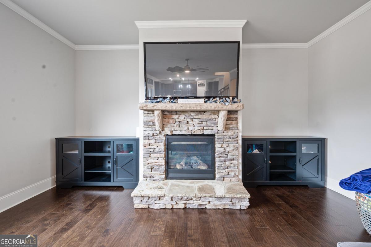 6780 Rambling Vale Dawsonville, GA 30534 - Photo 19 of 52 a living room with a fireplace and wooden floor