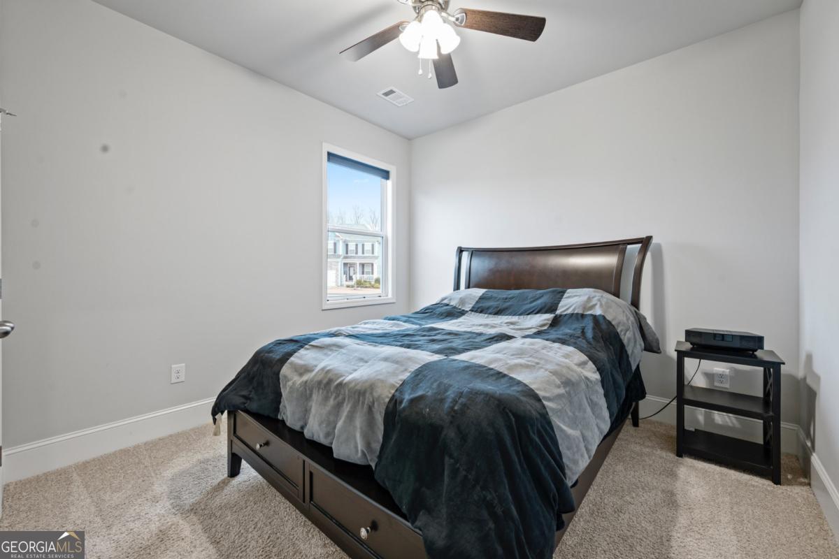 6780 Rambling Vale Dawsonville, GA 30534 - Photo 20 of 52 a bedroom with a bed and a chandelier