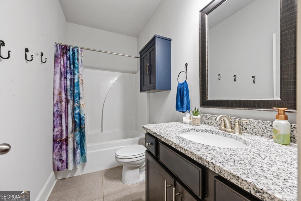 6780 Rambling Vale Dawsonville, GA 30534 - Photo 21 of 52 a bathroom with a granite countertop sink toilet and shower