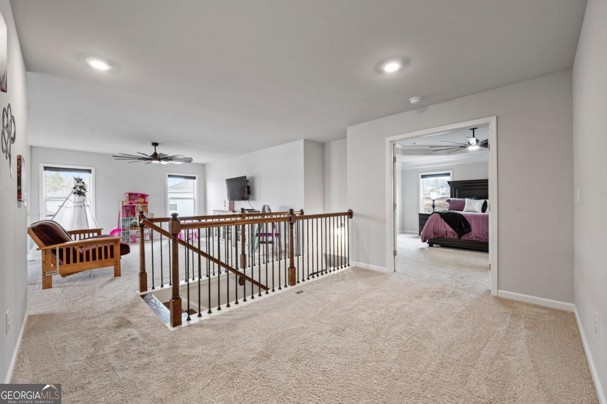 6780 Rambling Vale Dawsonville, GA 30534 - Photo 23 of 52 a view of a bedroom with furniture and a window