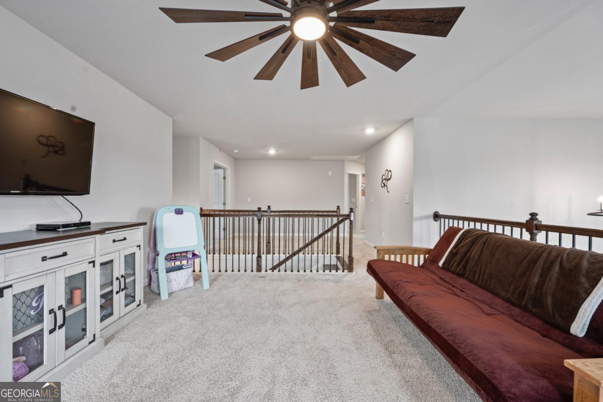 6780 Rambling Vale Dawsonville, GA 30534 - Photo 27 of 52 a living room with furniture and a flat screen tv