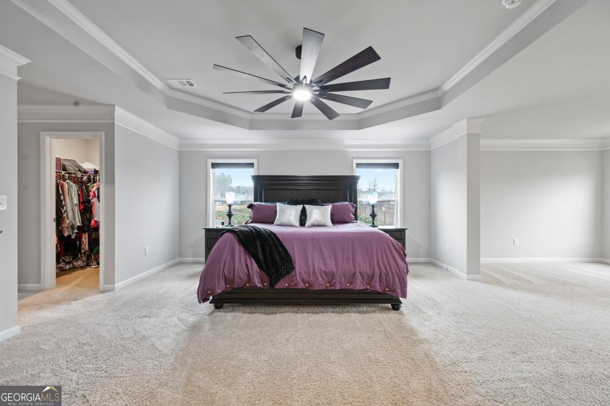 6780 Rambling Vale Dawsonville, GA 30534 - Photo 28 of 52 a bedroom with a bed and a chandelier