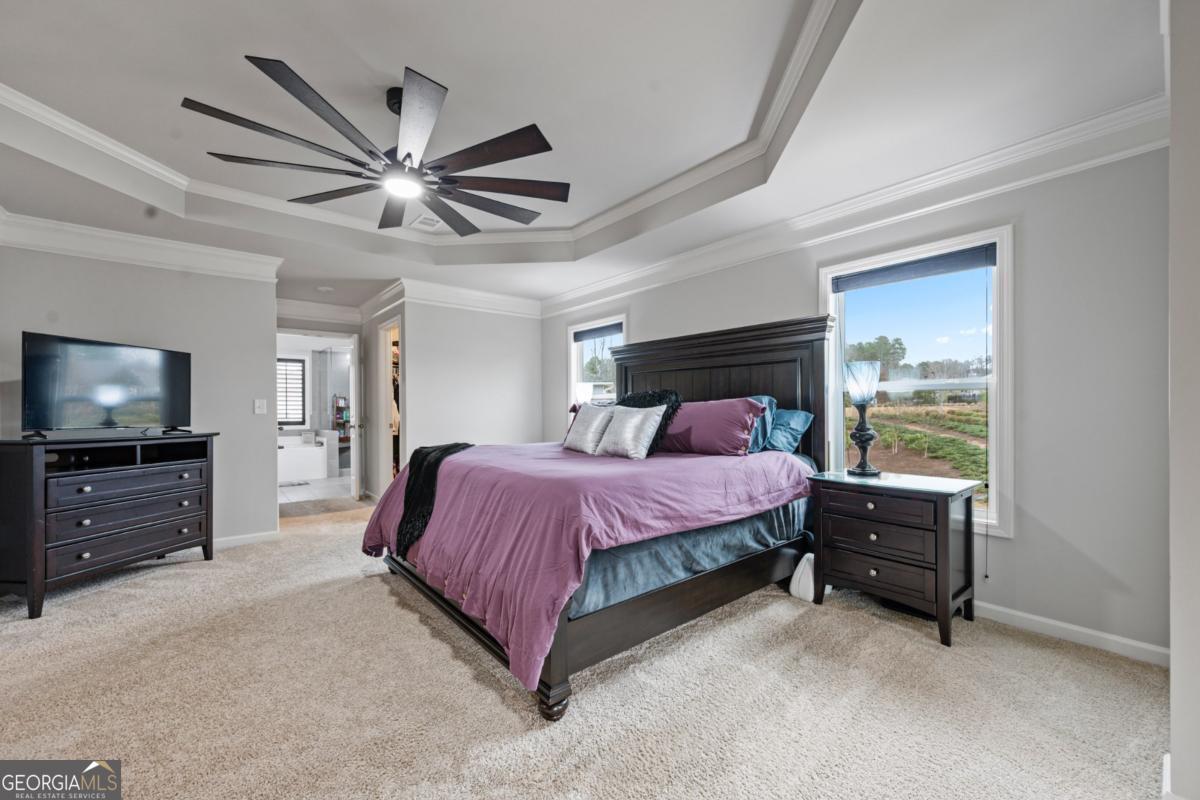 6780 Rambling Vale Dawsonville, GA 30534 - Photo 30 of 52 a spacious bedroom with a bed and a flat screen tv