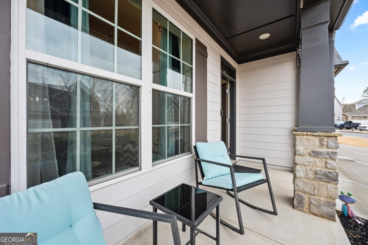 6780 Rambling Vale Dawsonville, GA 30534 - Photo 3 of 52 a view of a chair and table in the balcony