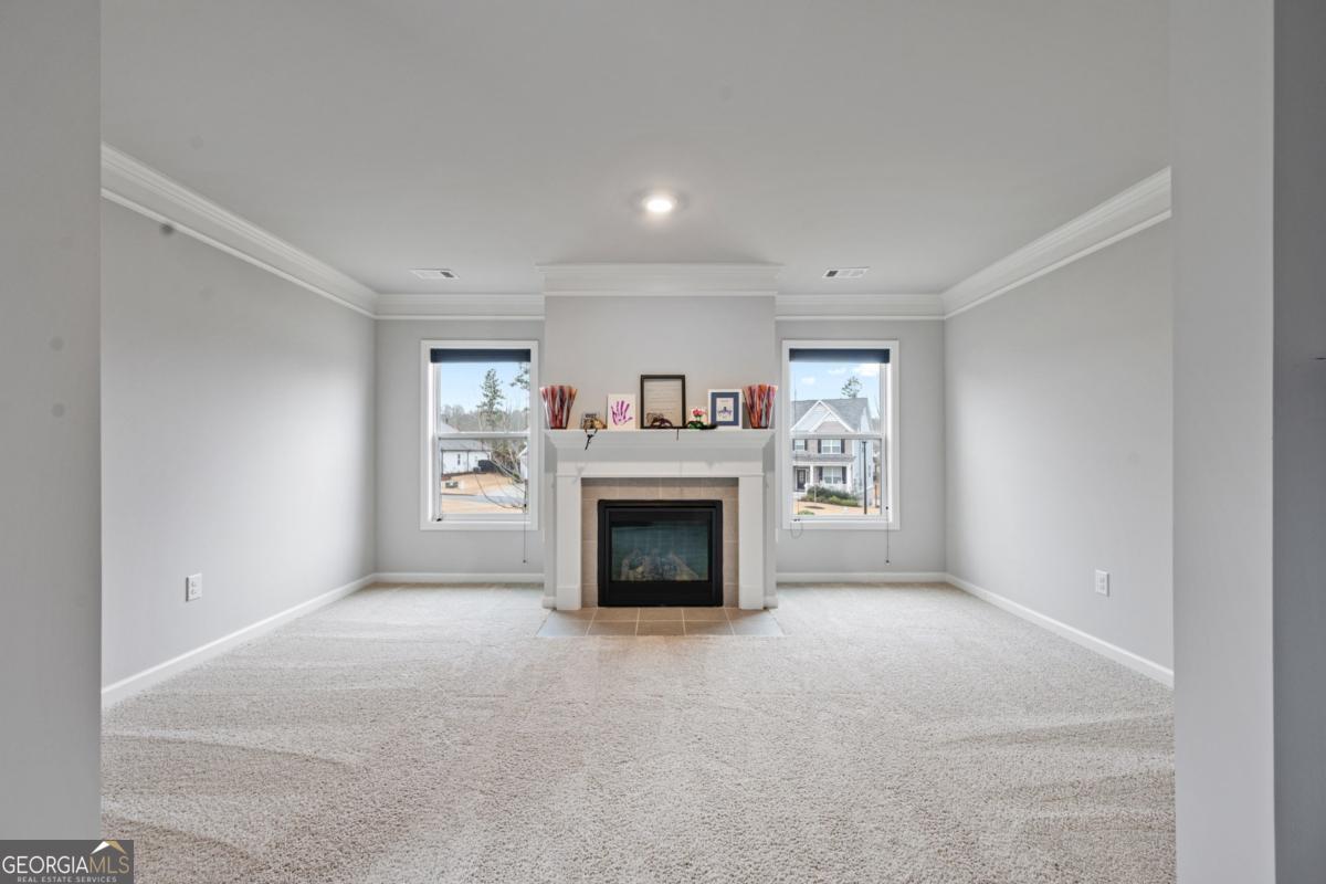 6780 Rambling Vale Dawsonville, GA 30534 - Photo 31 of 52 a view of an empty room with a fireplace and a window