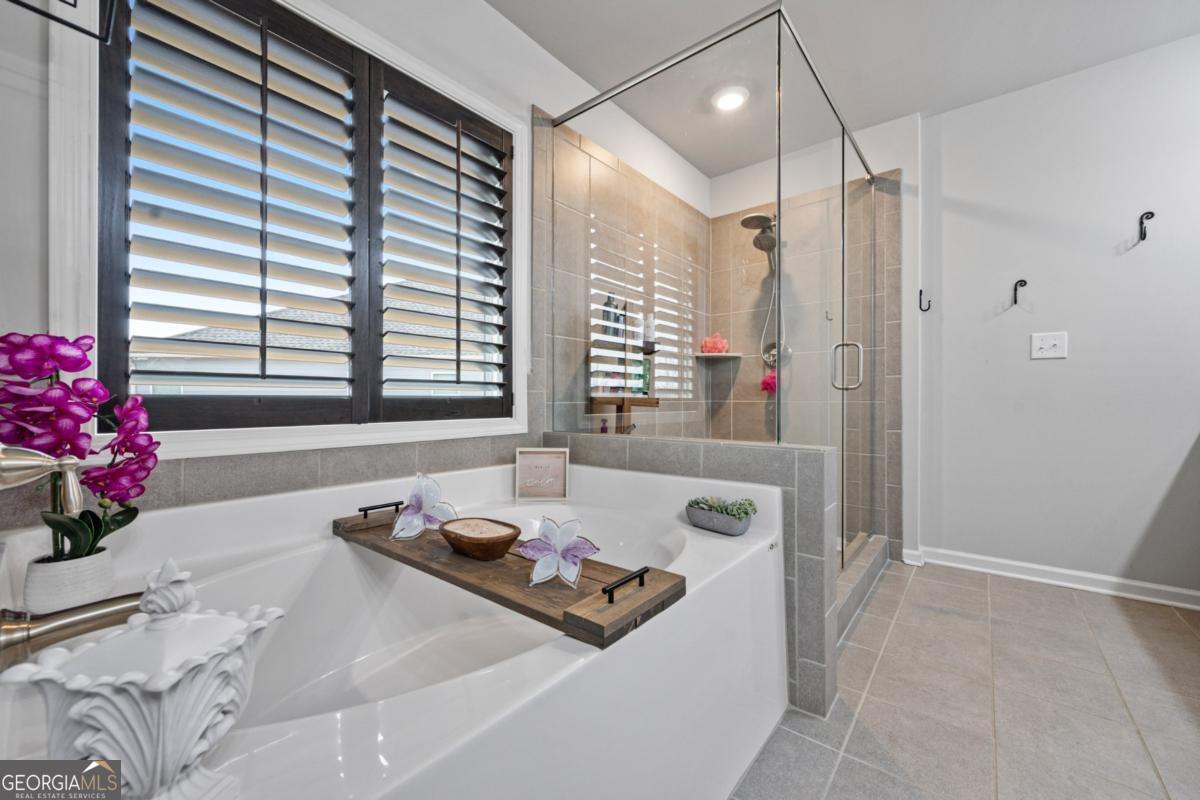 6780 Rambling Vale Dawsonville, GA 30534 - Photo 35 of 52 a bathroom with a tub sink and a mirror