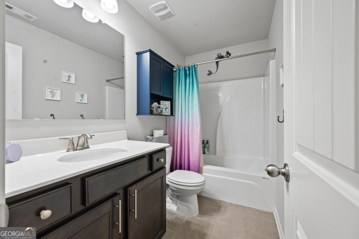 6780 Rambling Vale Dawsonville, GA 30534 - Photo 40 of 52 a bathroom with a sink a toilet a mirror and shower