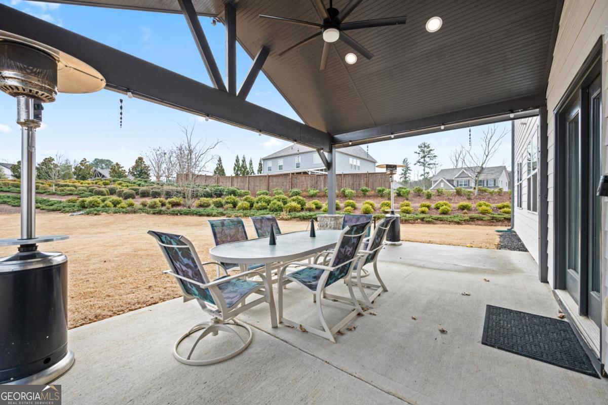 6780 Rambling Vale Dawsonville, GA 30534 - Photo 43 of 52 a view of a swimming pool with a table and chairs under an umbrella