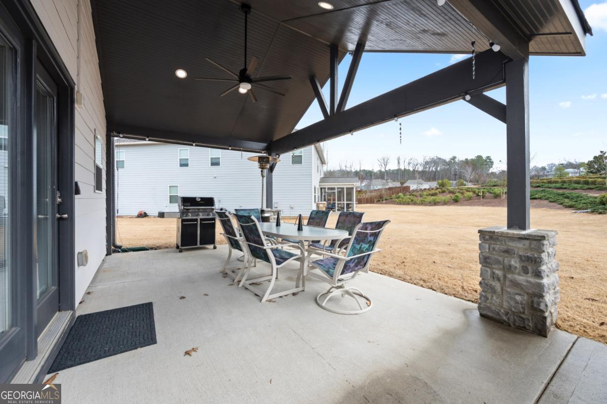 6780 Rambling Vale Dawsonville, GA 30534 - Photo 44 of 52 a dining room with furniture and a floor to ceiling window