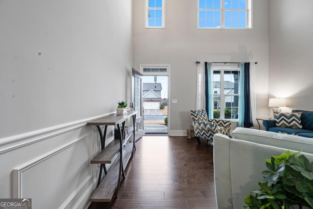 6780 Rambling Vale Dawsonville, GA 30534 - Photo 6 of 52 a hallway with wooden floor and furniture