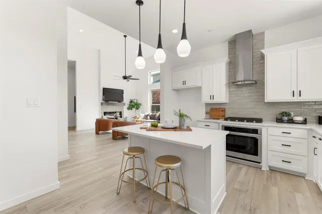 a open kitchen with stainless steel appliances granite countertop a stove a sink a center island and cabinets