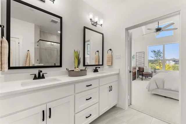 a en suite bathroom with double sink and a mirror