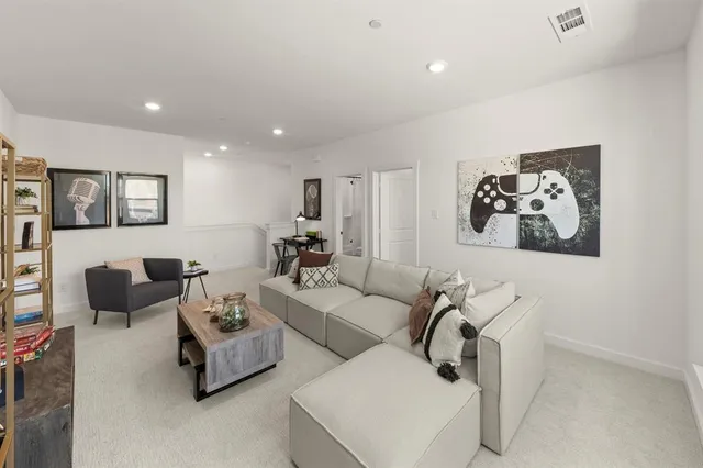 a living room with furniture and wall paintings