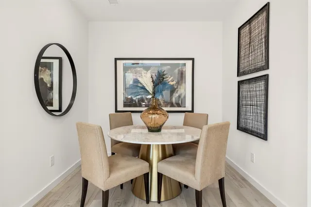 a dining room with furniture and a mirror