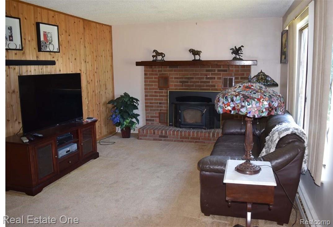 3838 East Allen Road Howell, MI 48855 - Photo 2 of 29 Family Room with natural fireplace and blower, really heats things up!