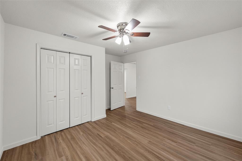 506 Rose Street Waco, TX 76704 - Photo 13 of 25 a view of an empty room with wooden floor