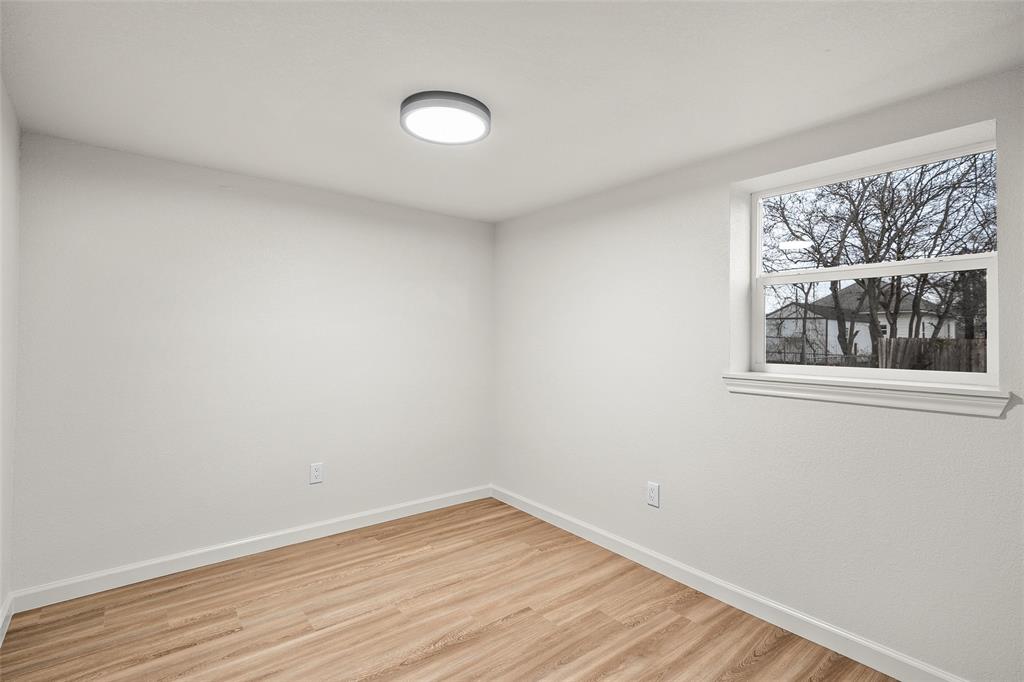 506 Rose Street Waco, TX 76704 - Photo 17 of 25 a view of an empty room with wooden floor and a window