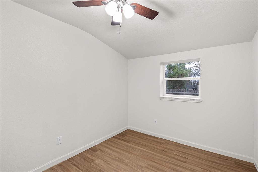 506 Rose Street Waco, TX 76704 - Photo 18 of 25 an empty room with a window and wooden floor