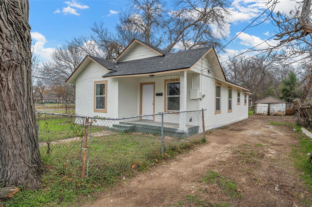 506 Rose Street Waco, TX 76704 - Photo 2 of 25 a view of a white house next to a yard with a large tree