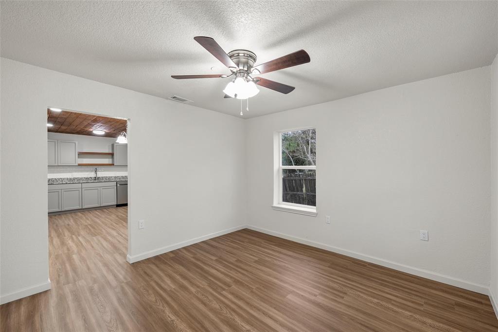 506 Rose Street Waco, TX 76704 - Photo 3 of 25 a view of a livingroom with a ceiling fan and wooden floor