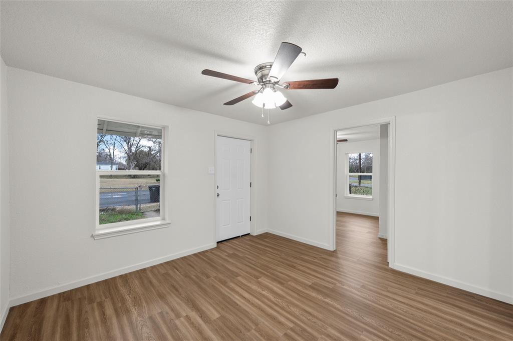 506 Rose Street Waco, TX 76704 - Photo 5 of 25 a view of an empty room with window and wooden floor