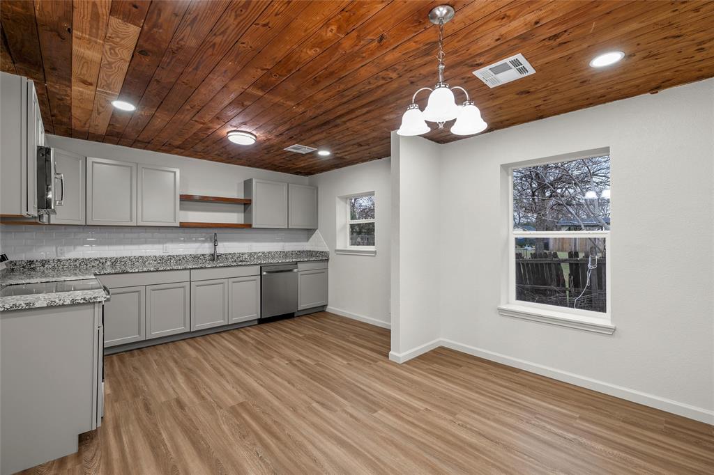 506 Rose Street Waco, TX 76704 - Photo 6 of 25 a kitchen with stainless steel appliances granite countertop a sink cabinets a stove and a refrigerator