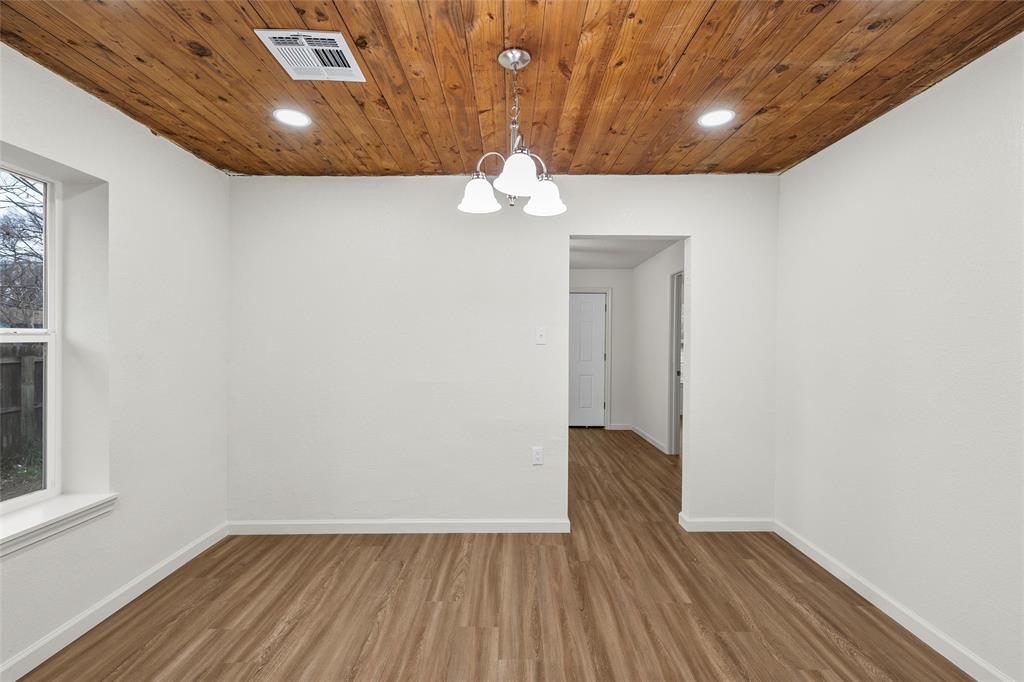 506 Rose Street Waco, TX 76704 - Photo 7 of 25 a view of an empty room with wooden floor and a window