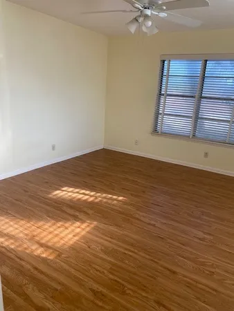 a view of a room with an empty space and wooden floor
