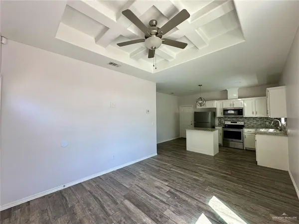 a kitchen with a refrigerator sink and cabinets
