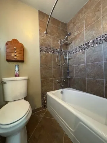 a view of an empty room with a ceiling fan