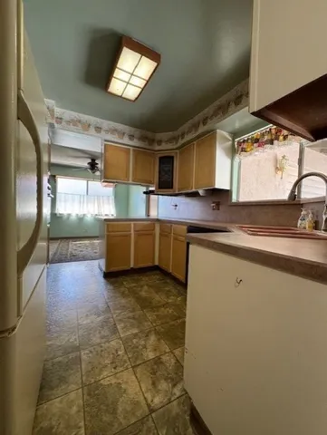 a kitchen with stainless steel appliances granite countertop a sink and a stove top oven
