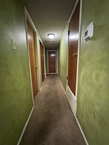 a bedroom with a bed and a flat tv screen on dresser