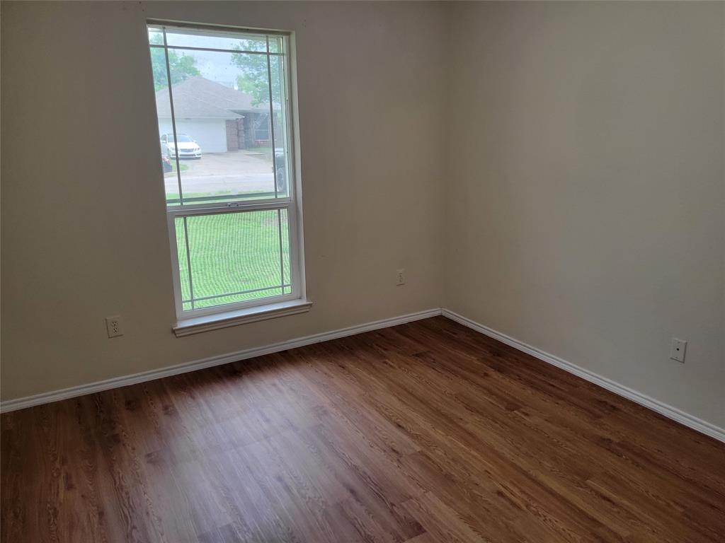 1764 Independence Road Blue Mound, TX 76131 - Photo 11 of 13 an empty room with wooden floor and windows