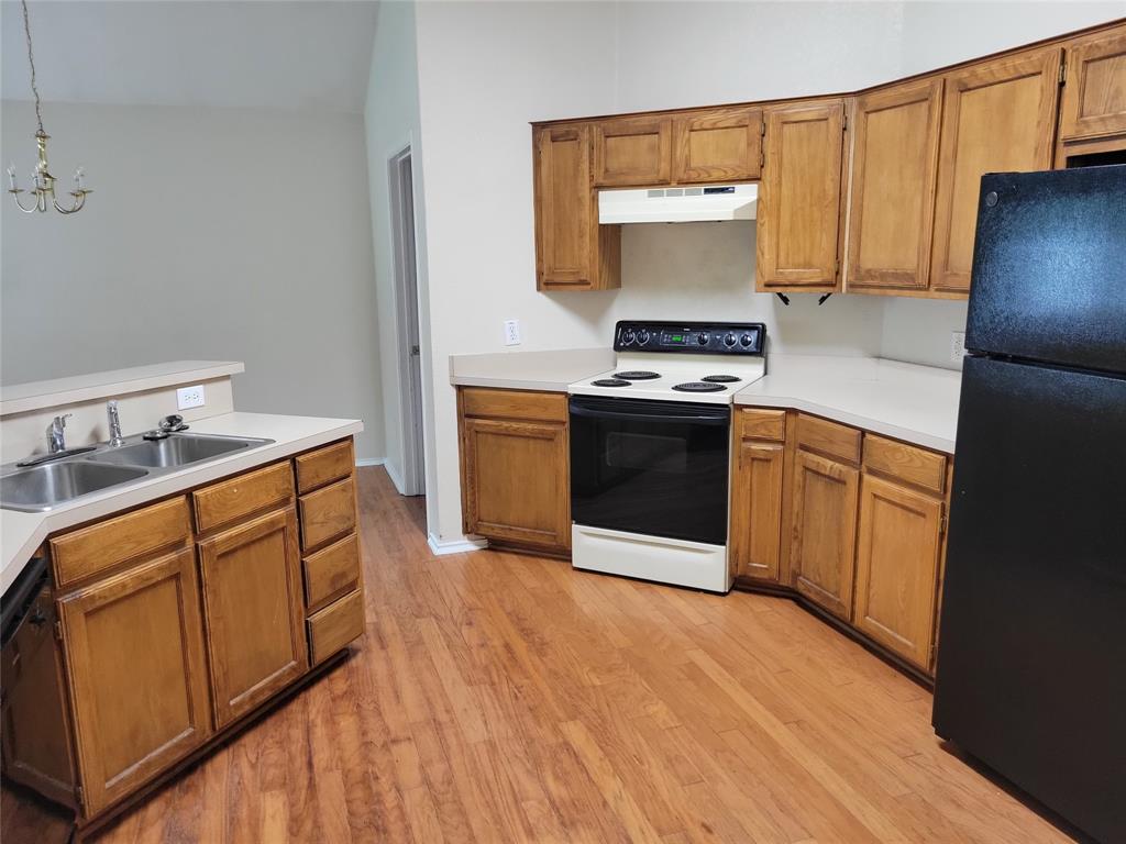 1764 Independence Road Blue Mound, TX 76131 - Photo 4 of 13 a kitchen with stainless steel appliances granite countertop a stove a sink and a refrigerator