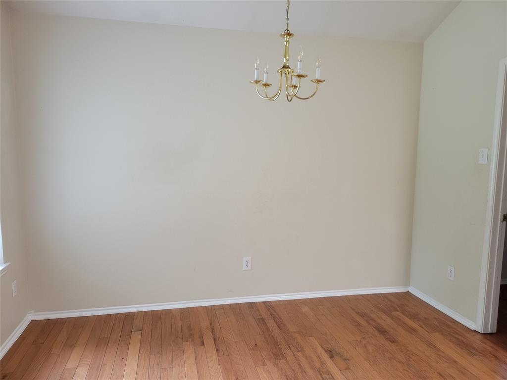 1764 Independence Road Blue Mound, TX 76131 - Photo 5 of 13 a view of empty room with wooden floor and chandelier