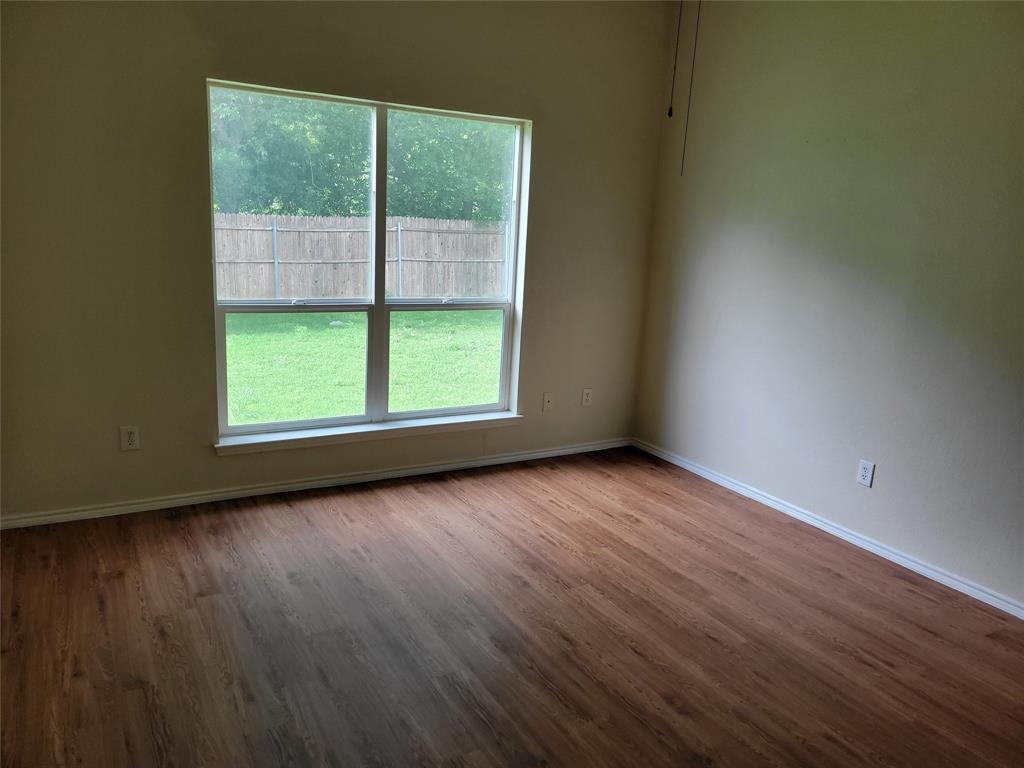 1764 Independence Road Blue Mound, TX 76131 - Photo 6 of 13 an empty room with wooden floor and windows