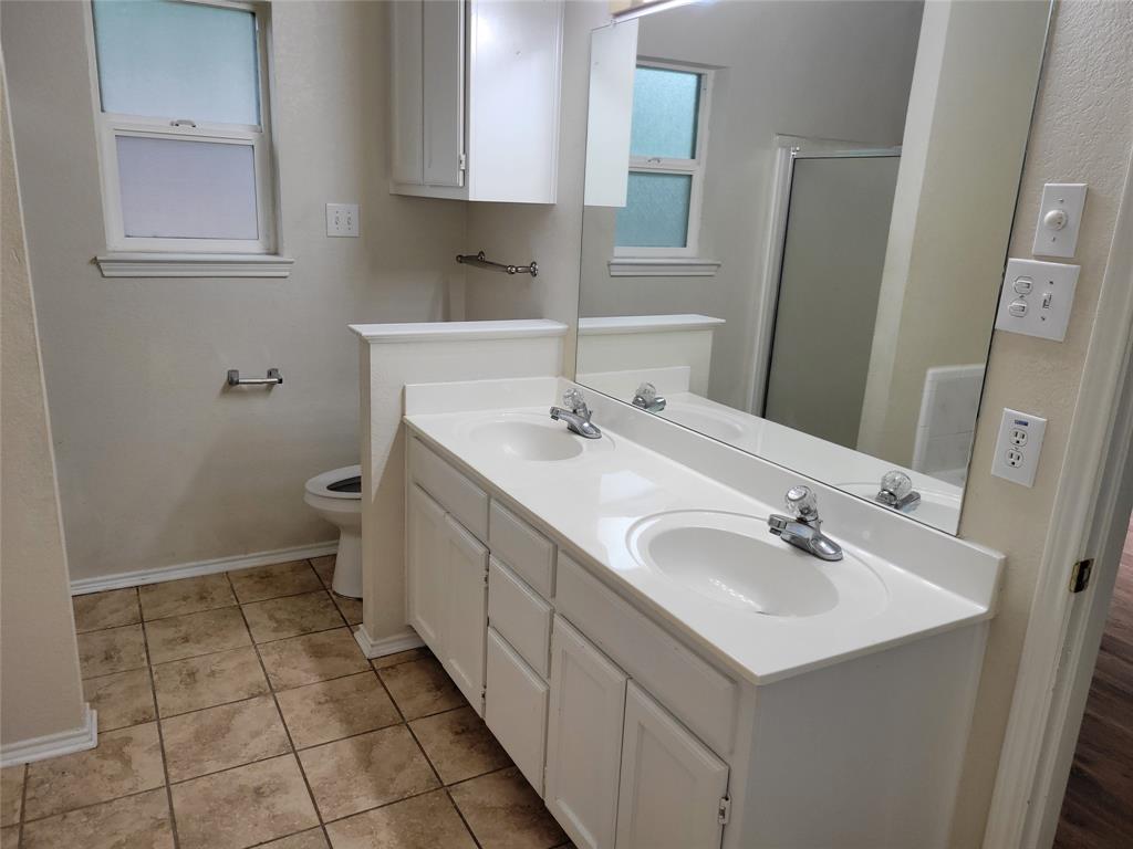 1764 Independence Road Blue Mound, TX 76131 - Photo 8 of 13 a bathroom with a sink a toilet and a mirror