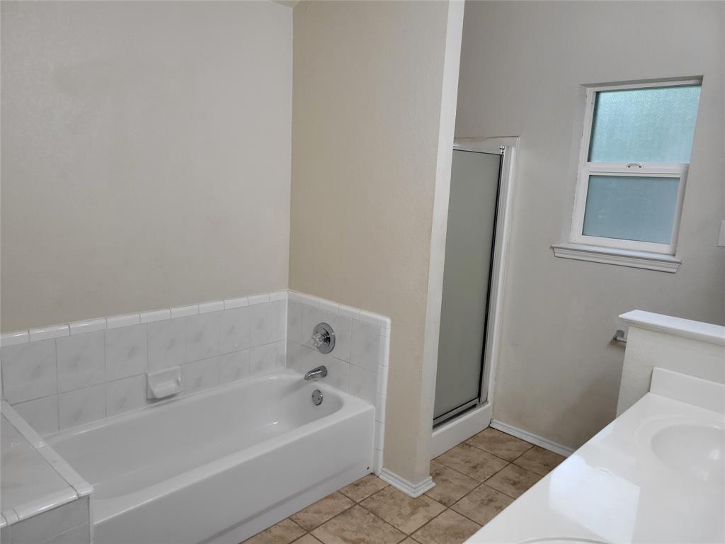1764 Independence Road Blue Mound, TX 76131 - Photo 9 of 13 a bathroom with a bathtub and a shower