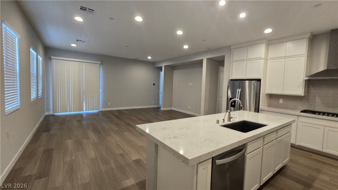 852 Weston Ridge Street Henderson, NV 89011 - Photo 26 of 28 An open-concept living area seamlessly connects to a modern kitchen with a spacious island.