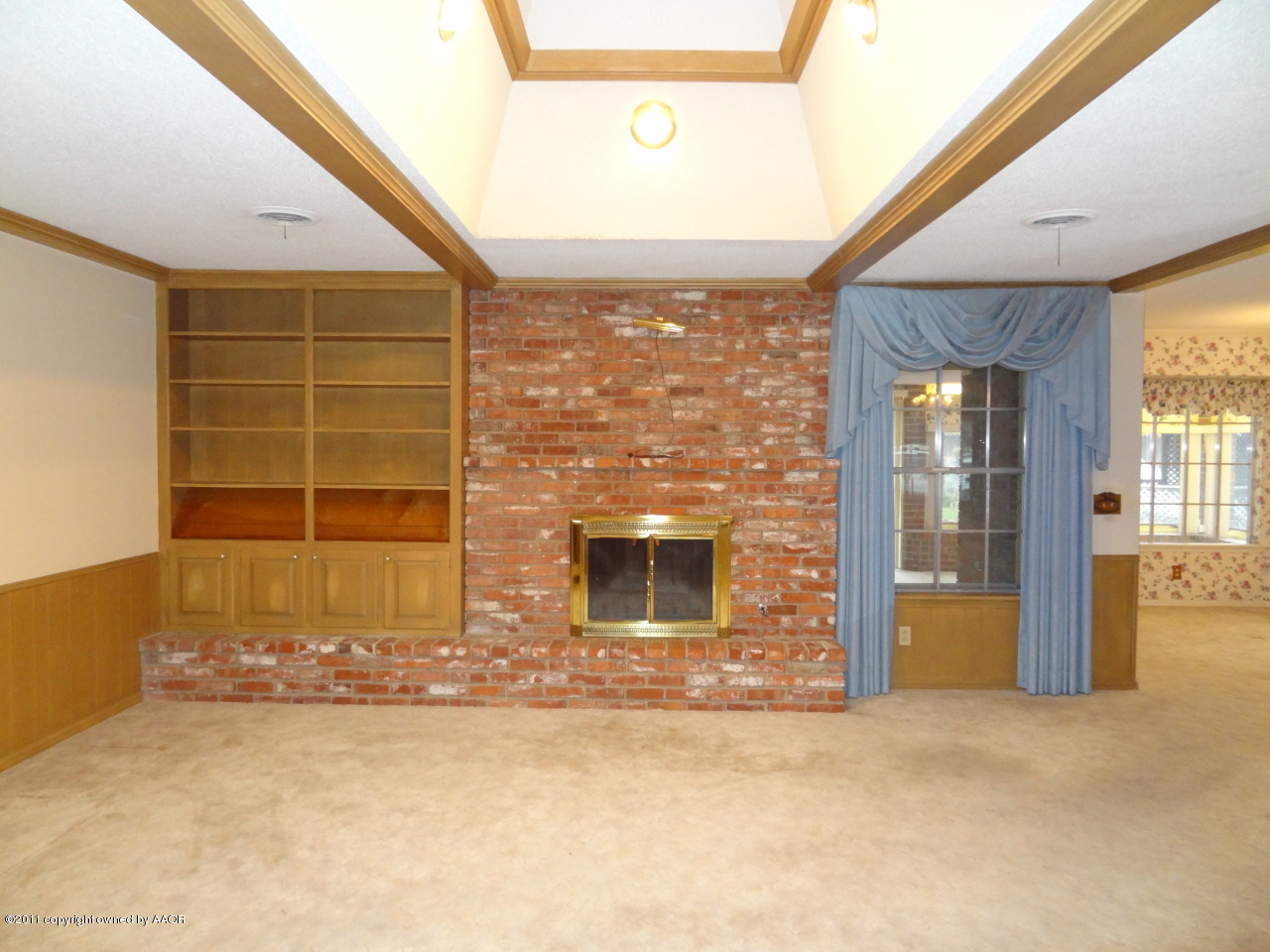 3308 Lombard Road Amarillo, TX 79106 - Photo 12 of 13 an empty room with a fireplace and windows