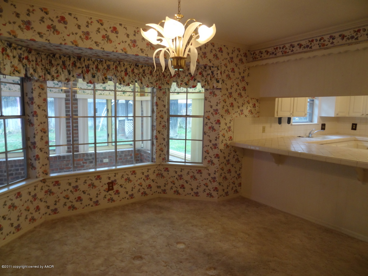 3308 Lombard Road Amarillo, TX 79106 - Photo 9 of 13 a kitchen with a sink and chandelier