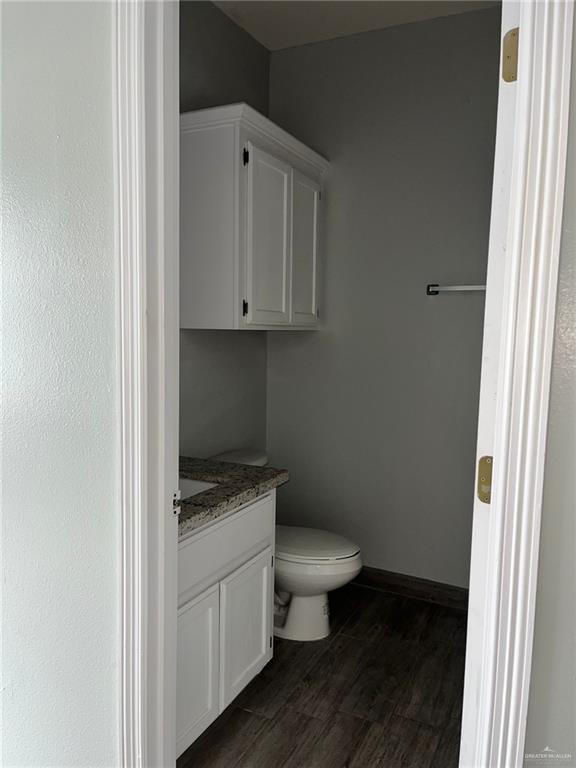 211 Baltic Avenue, Unit D Edinburg, TX 78539 - Photo 15 of 23 Half bath with vanity and dark wood finished floors
