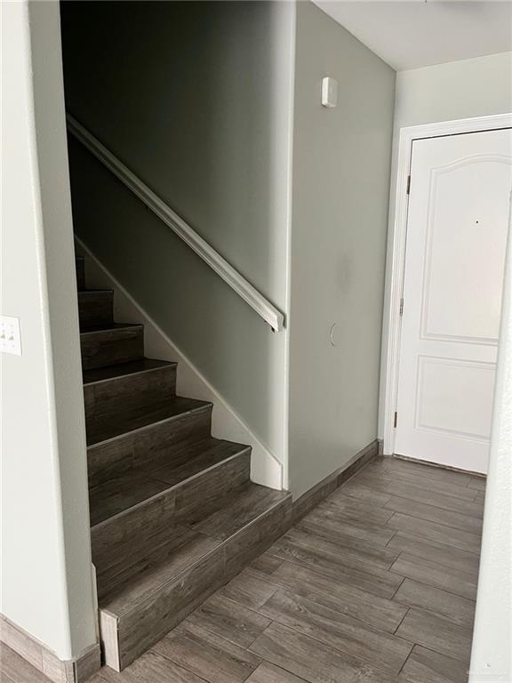 211 Baltic Avenue, Unit D Edinburg, TX 78539 - Photo 19 of 23 Staircase with wood finished floors and baseboards