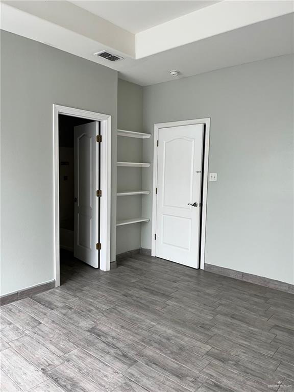 211 Baltic Avenue, Unit D Edinburg, TX 78539 - Photo 20 of 23 Unfurnished bedroom with wood finished floors