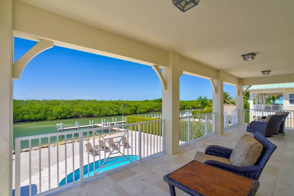 a view of an outdoor dining space with a table and chairs
