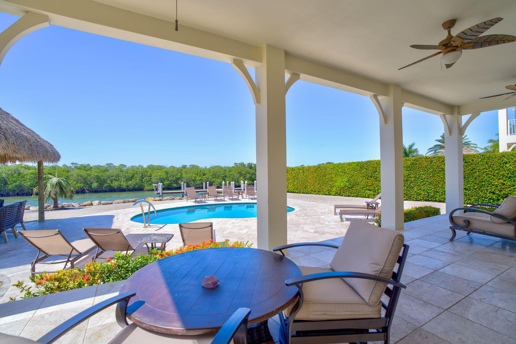 2394 Coco Plum Drive Marathon, FL 33050 - Photo 47 of 56 a view of a patio with lawn chairs next to a yard