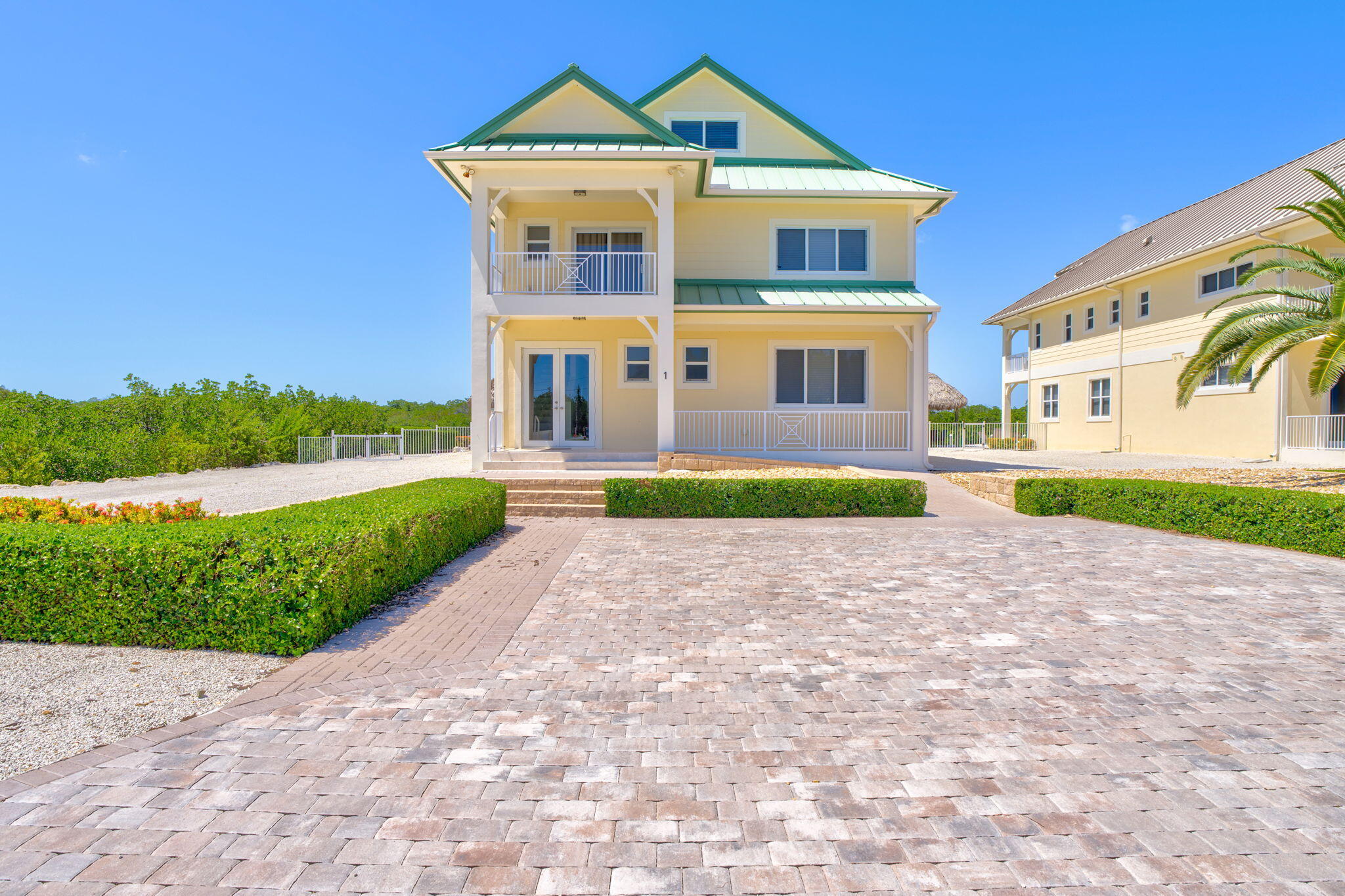 2394 Coco Plum Drive Marathon, FL 33050 - Photo 53 of 56 a front view of a house with a yard and potted plants
