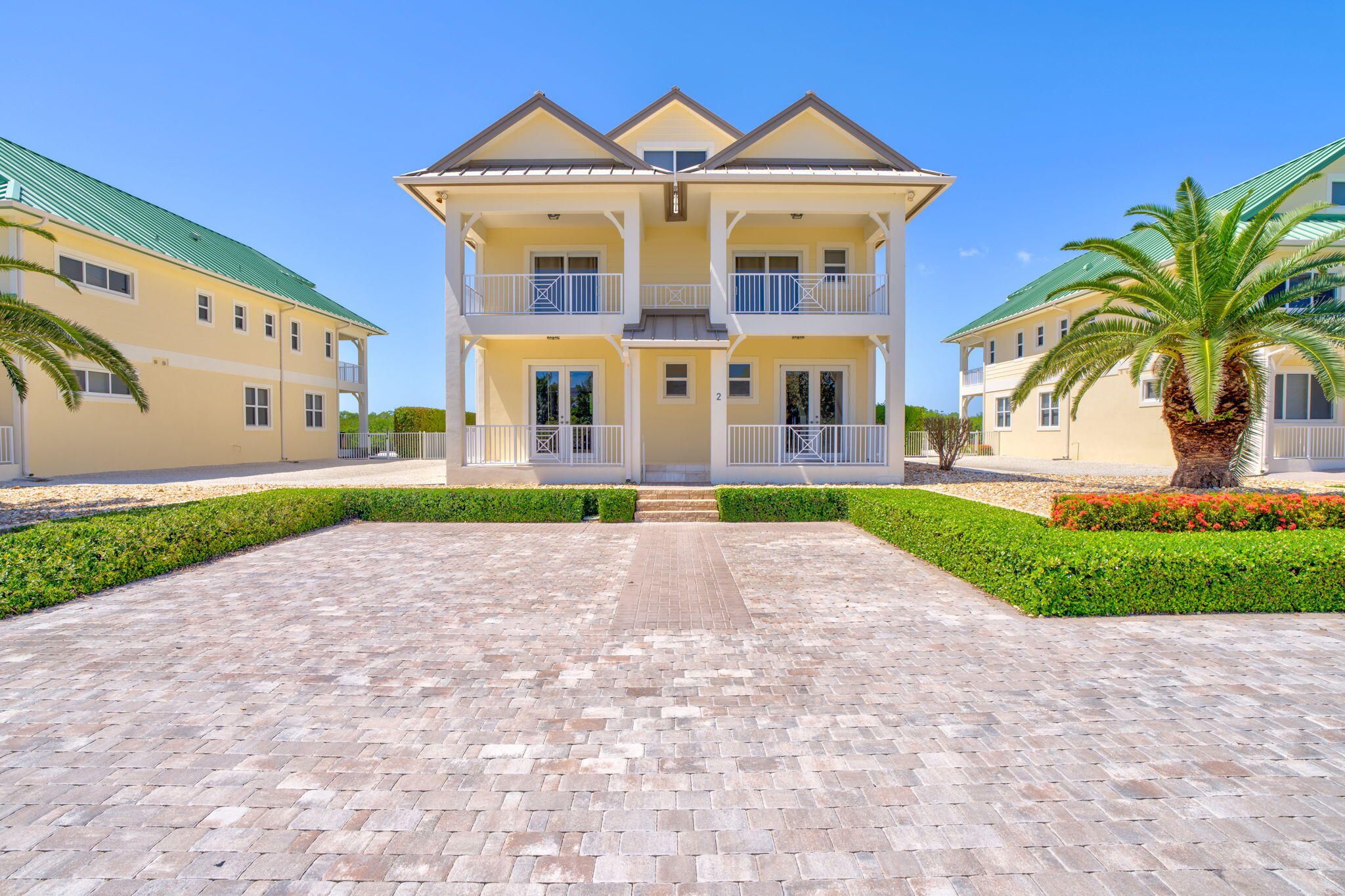 2394 Coco Plum Drive Marathon, FL 33050 - Photo 54 of 56 a front view of a house with a yard and garage